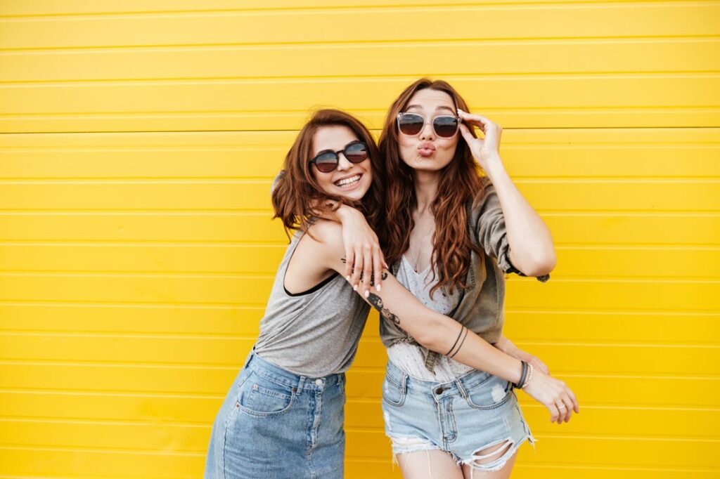 two young women hugging and smiling after meeting through one of the best friendship apps