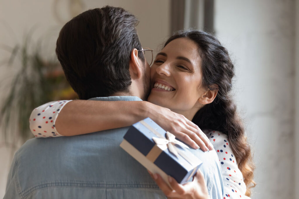 Coworkers hugging after receiving 50 dollar gift ideas