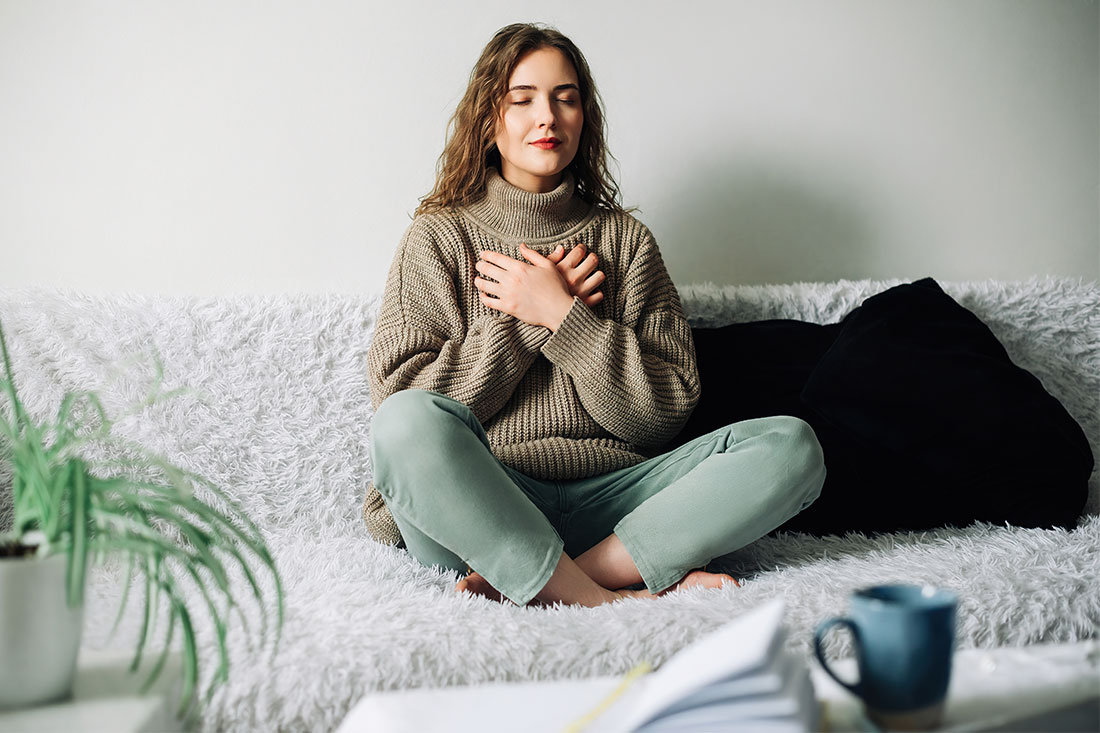 Woman practicing breathing exercises to reduce stress and anxiety