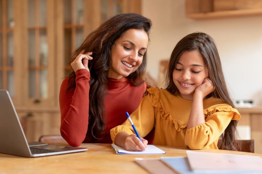 Mother and daughter sitting together learning how to make goal setting for kids