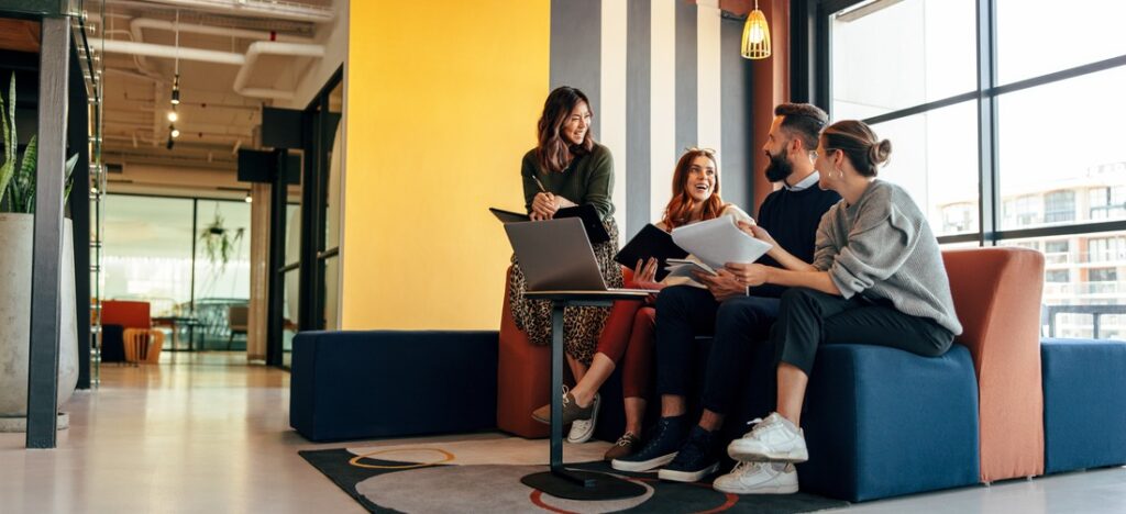 a group of people sitting together and talking to each other