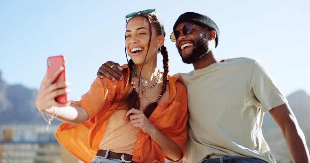 a man and a woman taking a selfie on the woman's phone