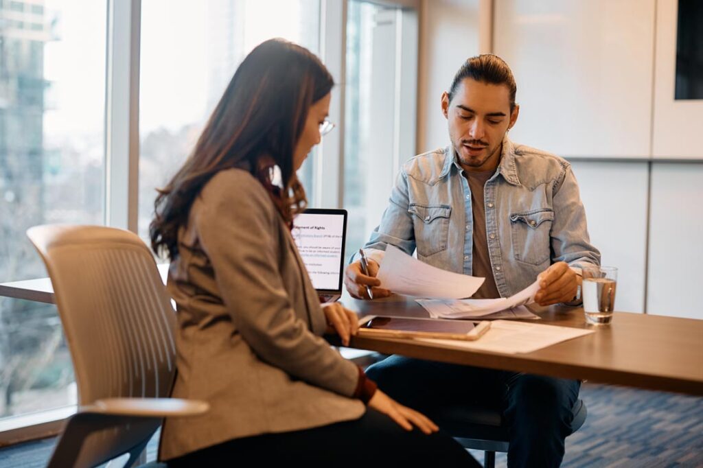 man negotiating severance pay with HR representative