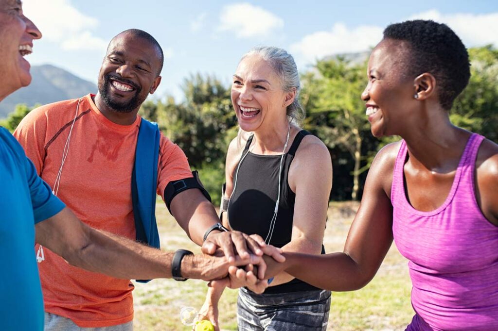 Happy group of people after accomplishing their new year's resolution ideas of exercising together