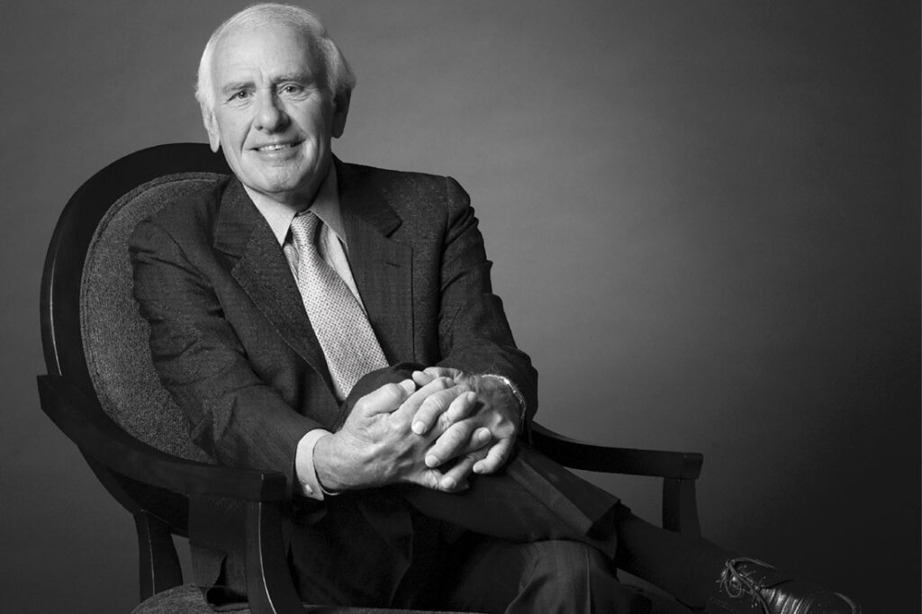 headshot of Jim Rohn posing on a chair