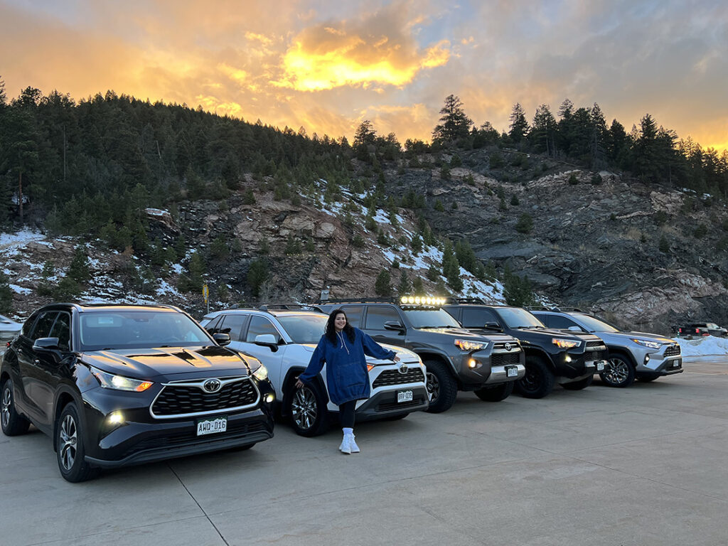 Michelle Perez standing in front of her Turo car rental fleet