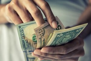 Close-up hands counting money american dollars