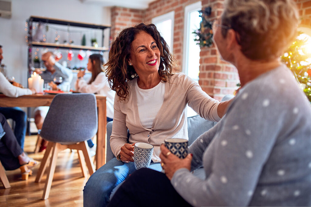 middle aged woman having a financial planning conversation with her aging parent in a coffee shop